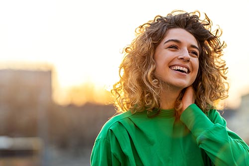 Woman smiles during sunset