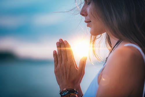 Woman meditates in sun