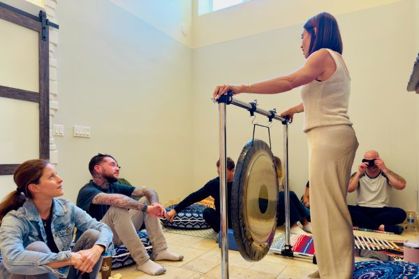 Participants gathered around a gong during a therapeutic sound session