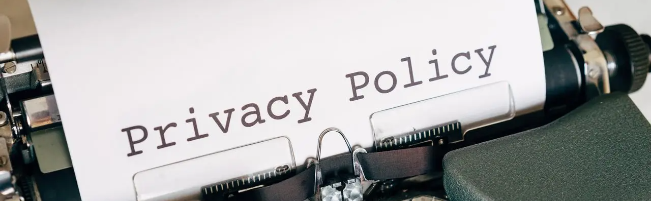 Close-up of a typewriter showing the words “Privacy Policy” on the paper.